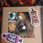 Box of Halloween-themed cupcakes / oat balls with decorative stickers on a dark background