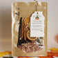 Pouch of potpourri with a tag on a neutral background with a pumpkin and leaves.