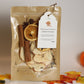 Homestead Orchard simmer potpourri package with dried fruits and spices, featuring a tag.