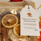 Homestead Orchard simmer potpourri package with dried fruits and spices, featuring a tag.