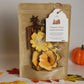Pouch of pumpkin spice simmer potpourri mix with flowers and leaves, labeled 'Pumpkin Spice' on a neutral background.