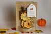 Pouch of pumpkin spice simmer potpourri mix with flowers and leaves, labeled 'Pumpkin Spice' on a neutral background.